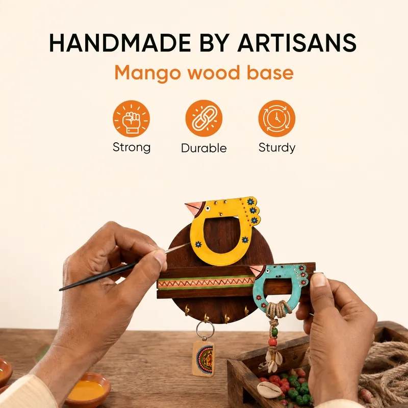 Colourful wooden bird key holder shown with decorative painting details