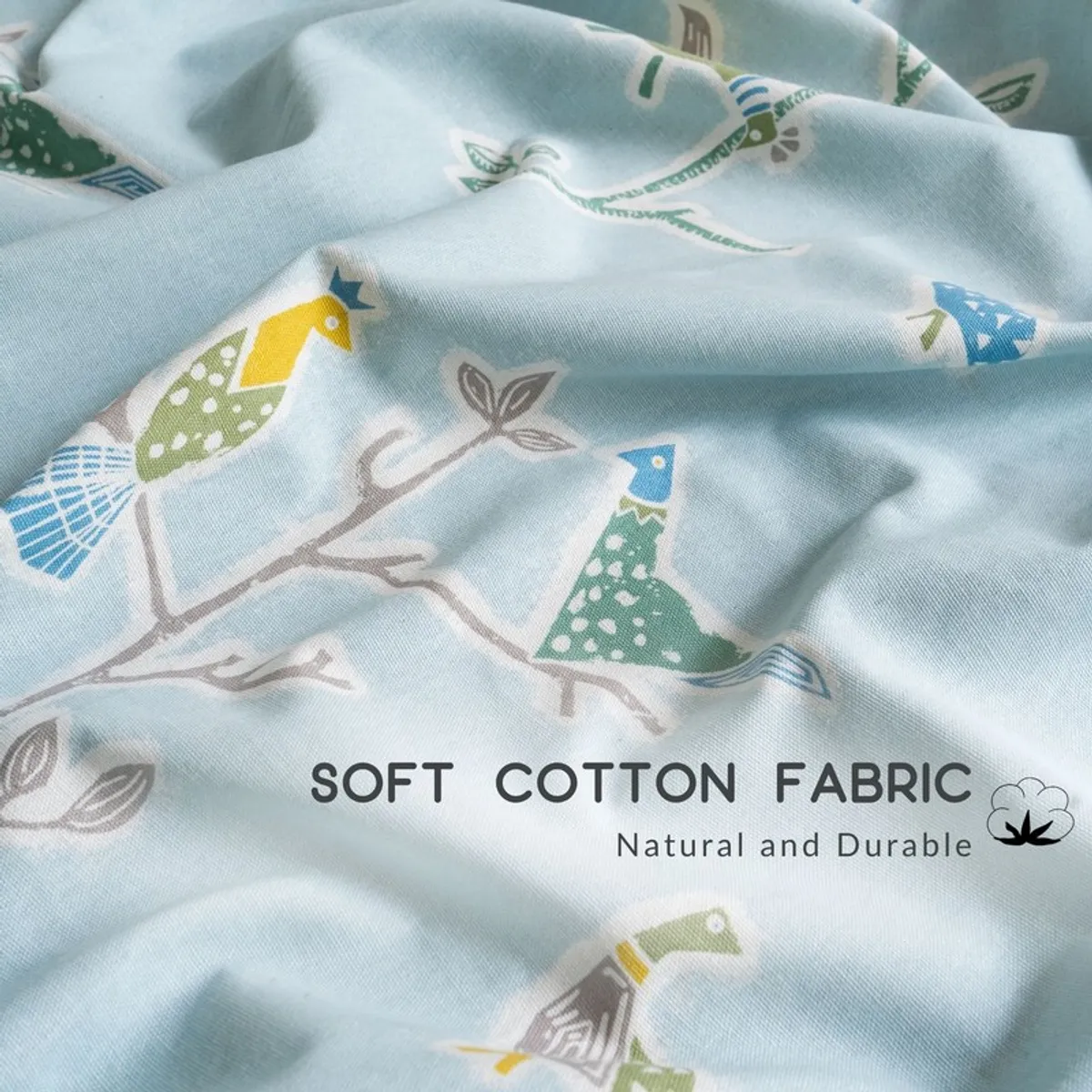Close-up of colourful bird print on light blue curtain fabric