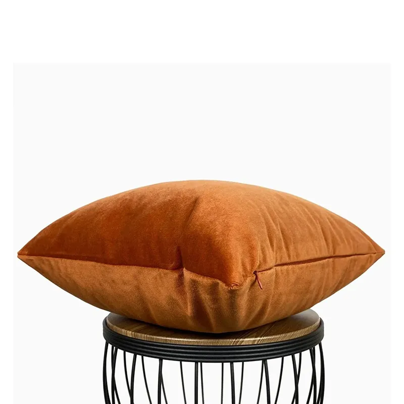 Side view of a rust velvet cushion cover showing zipper closure