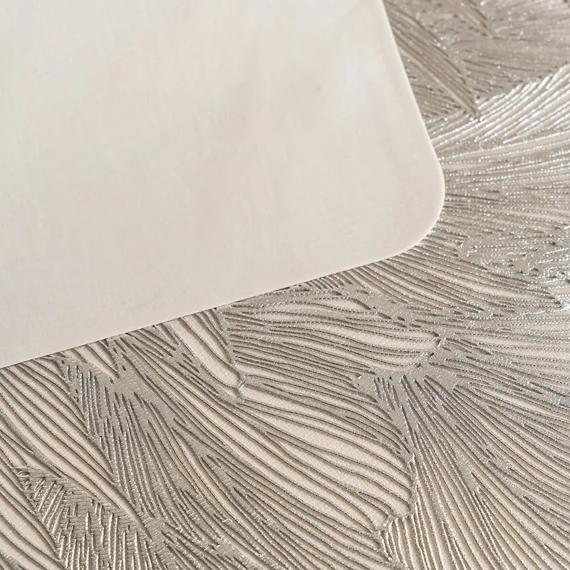 Close-up of the grey feather-like textured surface of the table mat