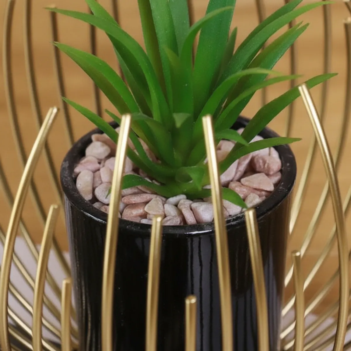 Close-up of black inner pot inside gold crown-wrap planter