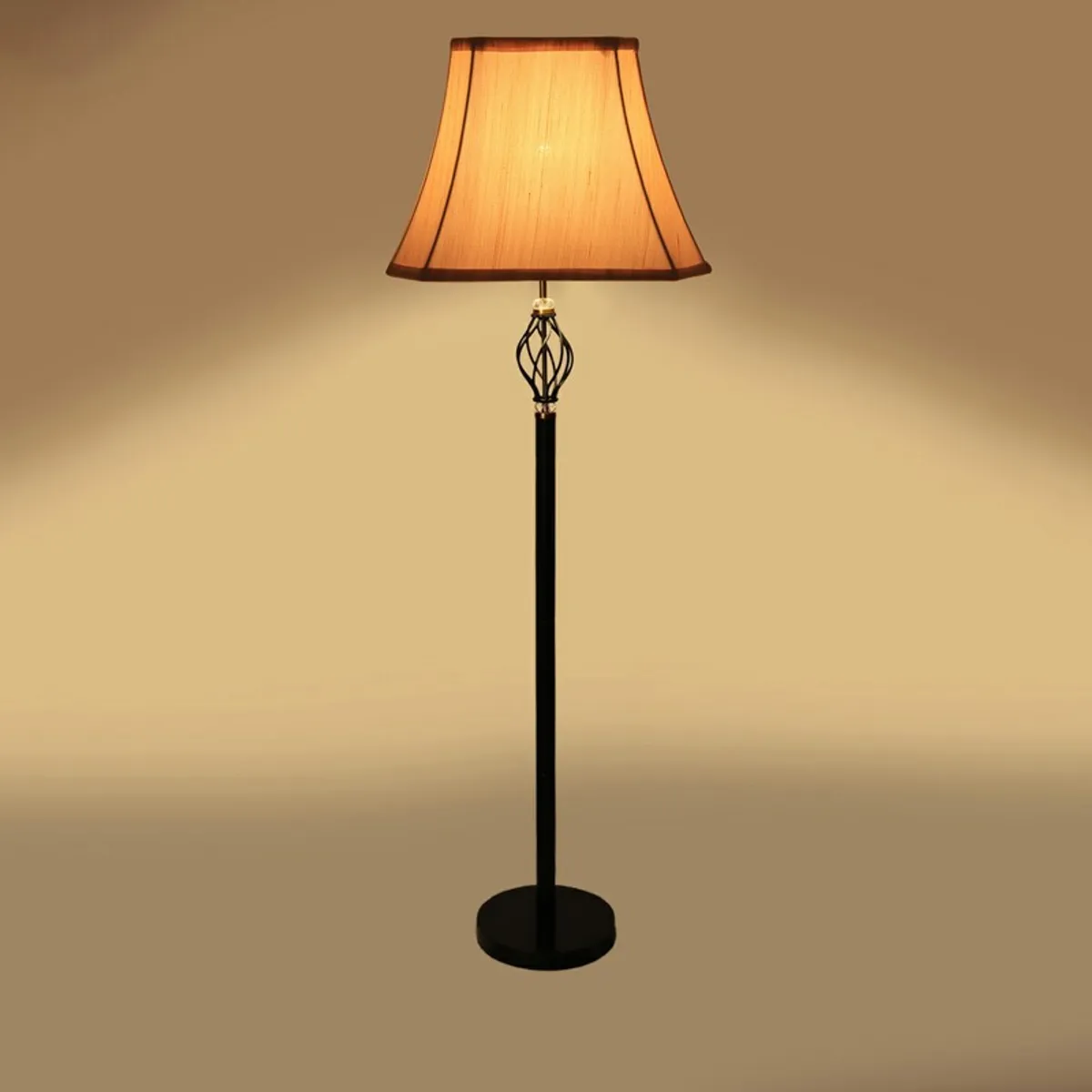 Warm-lit floor lamp with dark trimmed pleated shade on a plain background