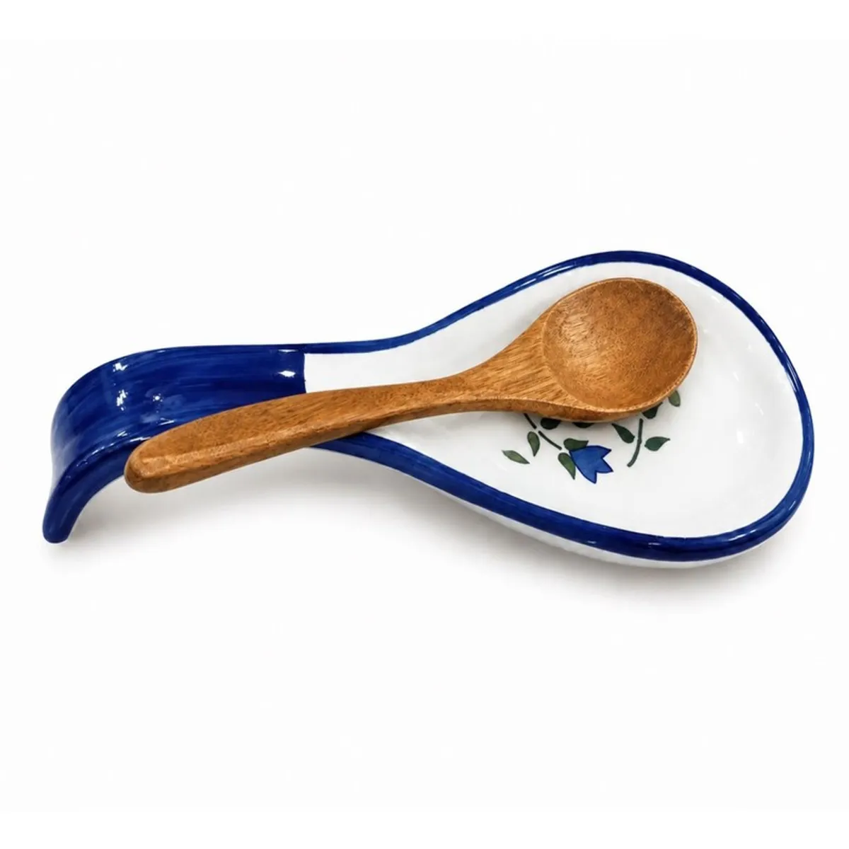 Blue and white ceramic spoon rest holding a wooden spoon
