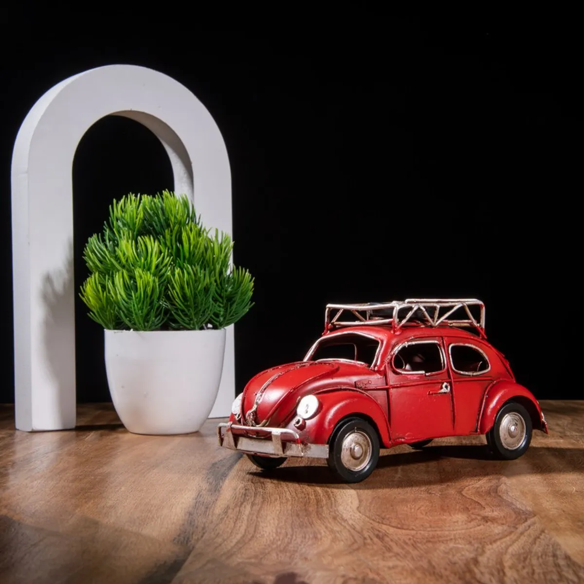 Red vintage car showpiece with roof rack on a tabletop
