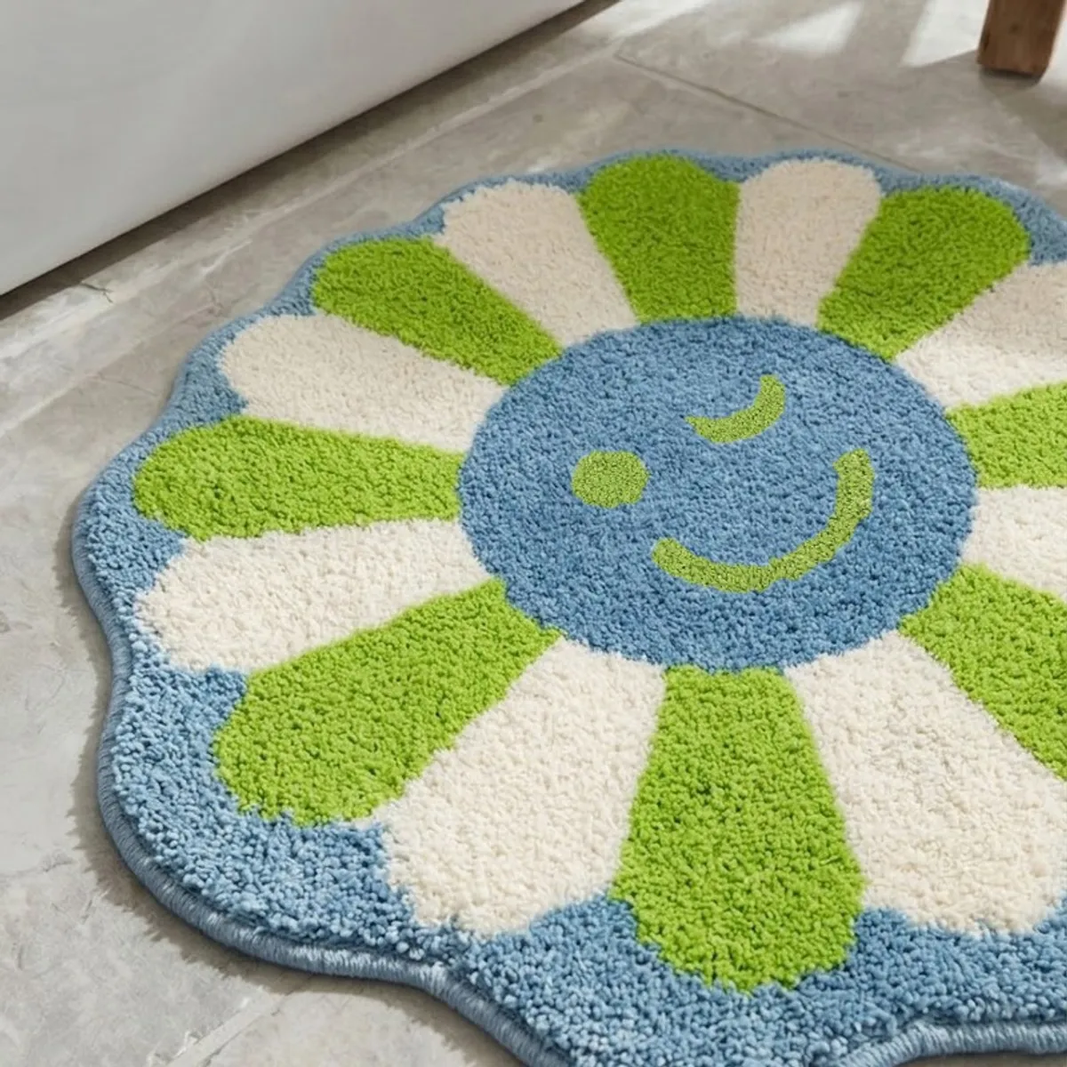 Close-up of the plush green, cream and blue floral bath mat surface.