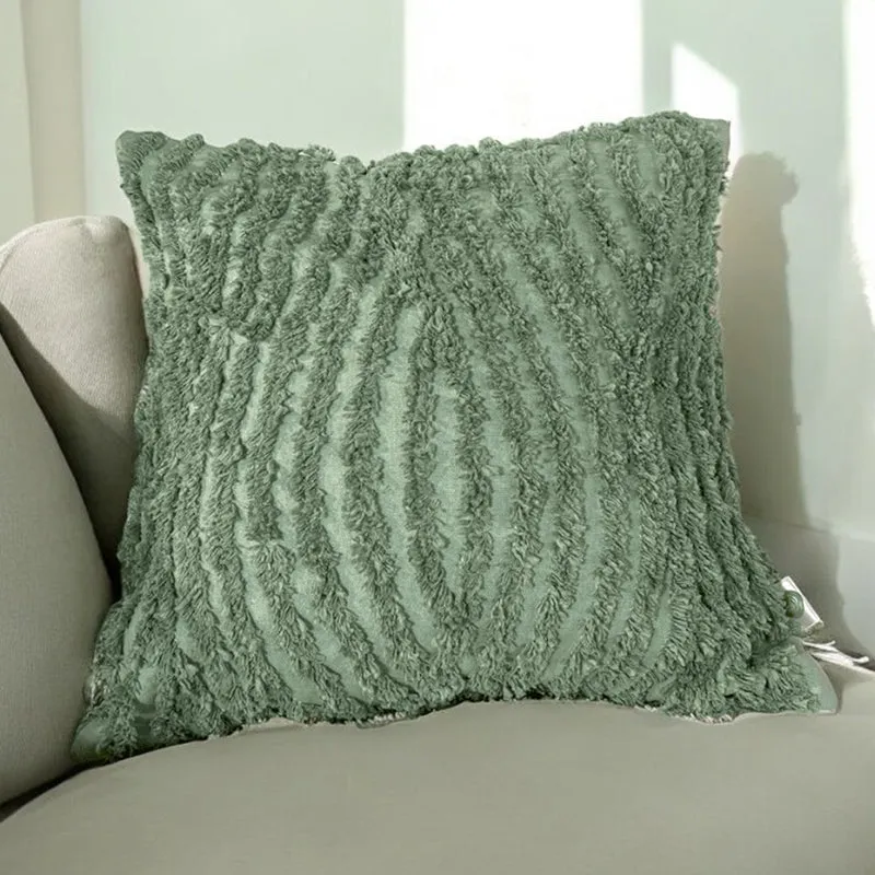 Single green tufted cushion cover resting on a light armchair