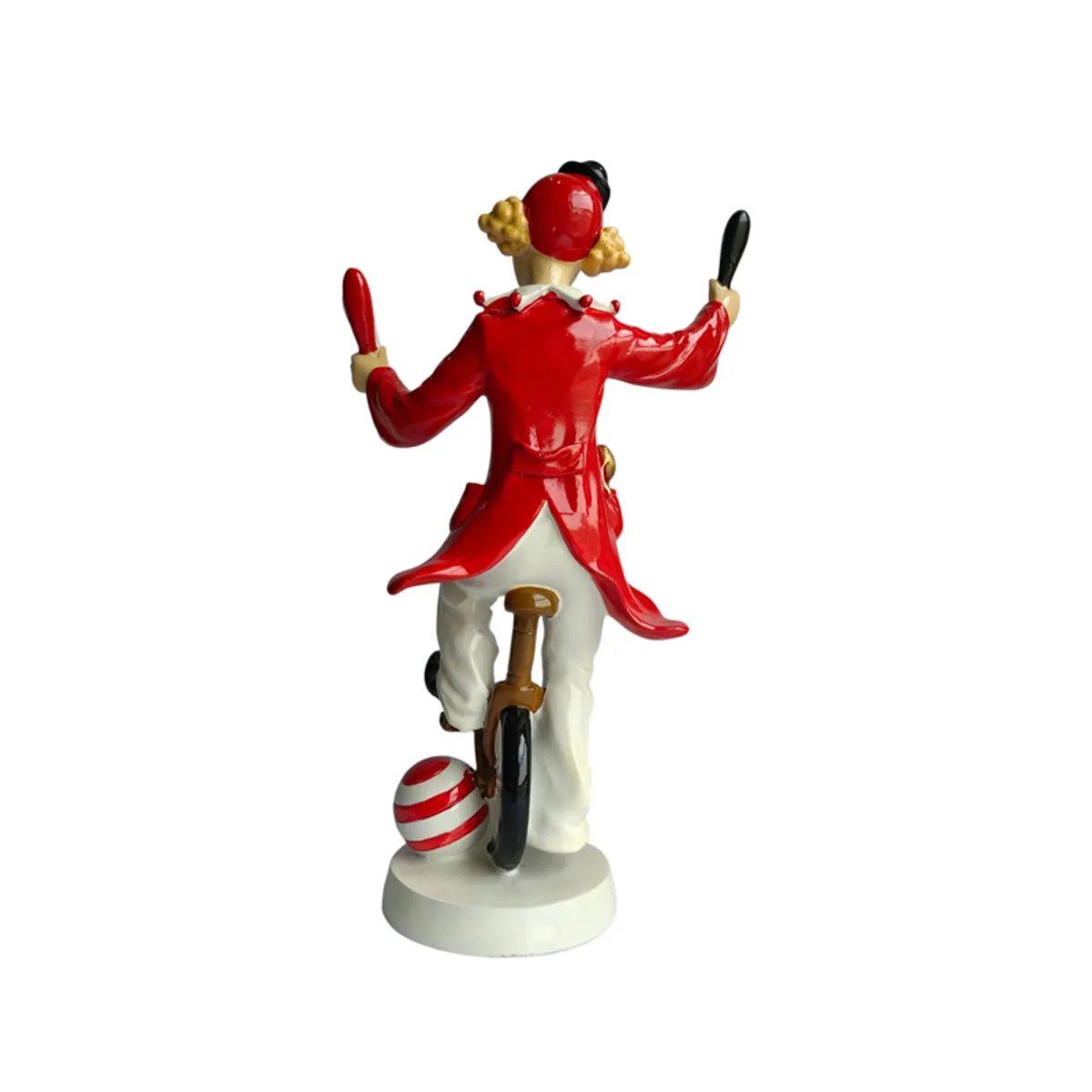 Rear view of the clown figurine balancing on a unicycle