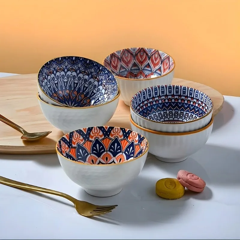 Five colourful mandala bowls arranged on a table, showing their patterned interiors.