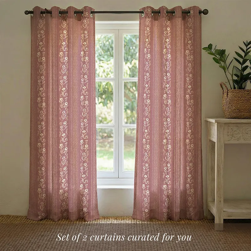 Two pink floral curtains hung across a window