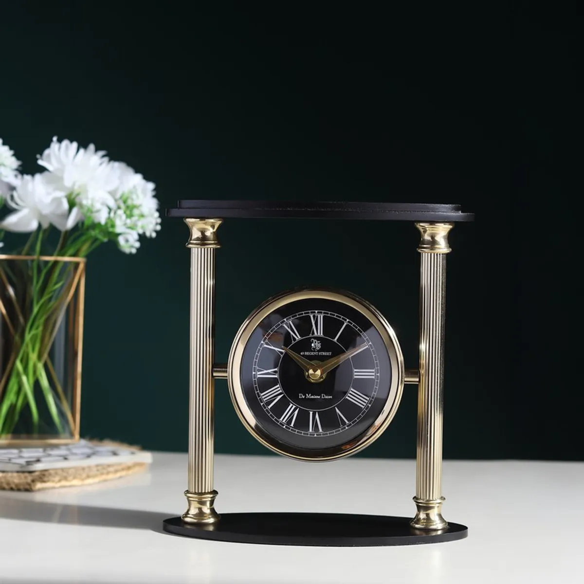 Front view of pillar-inspired gold and black table clock