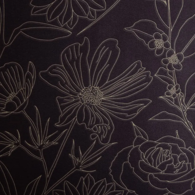 Close-up of dark purple floral line print on bedsheet fabric
