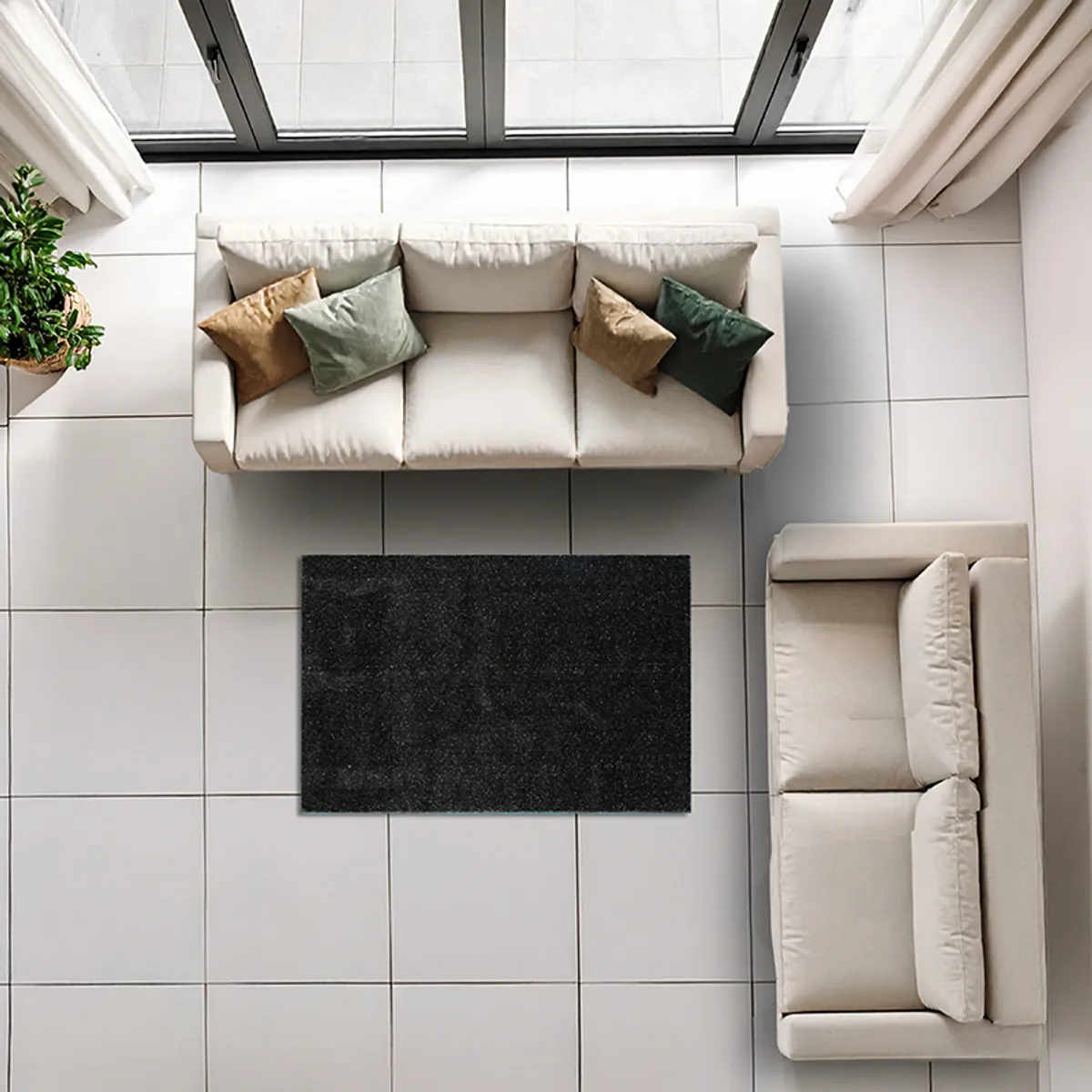 Top view of a black rectangular carpet arranged in a seating area