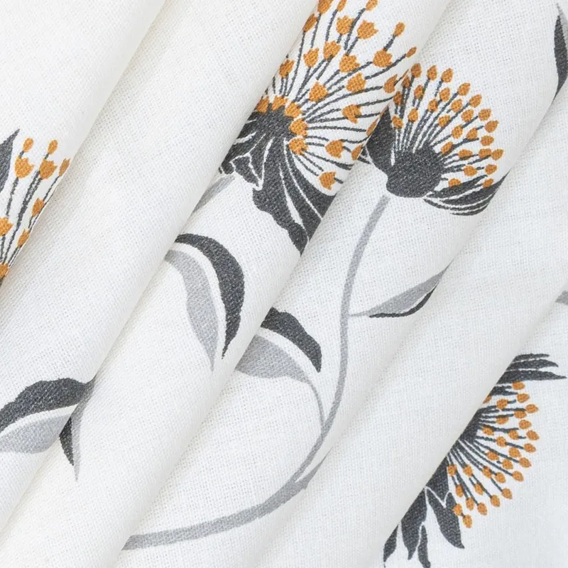 Detailed view of floral print on white bedsheet fabric