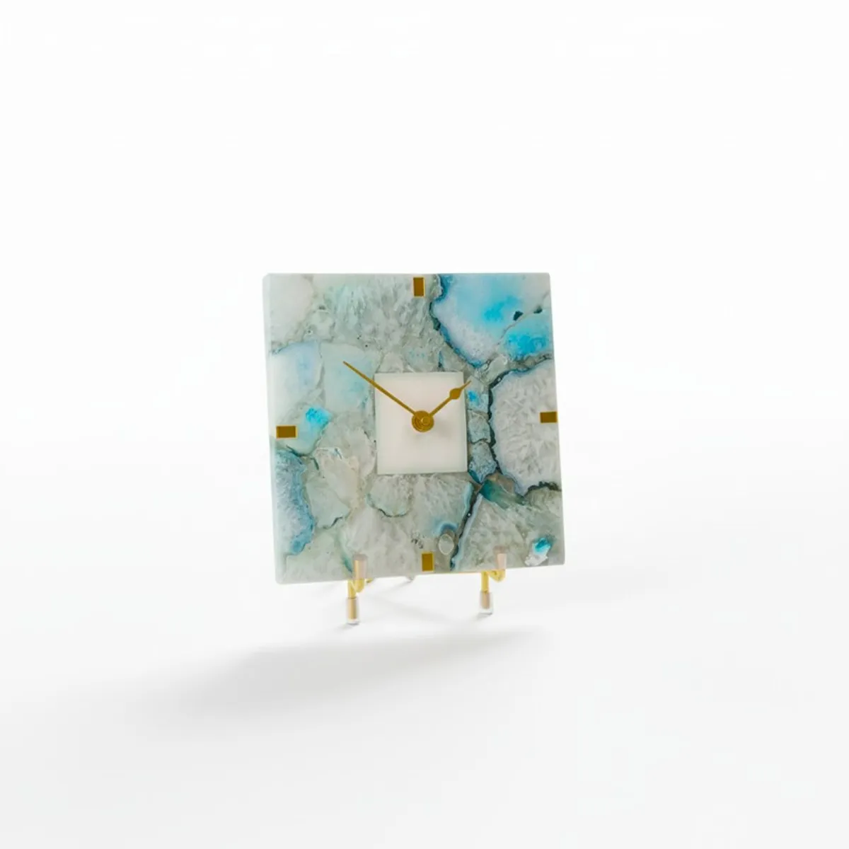Front view of a square agate table clock with gold hands and stand