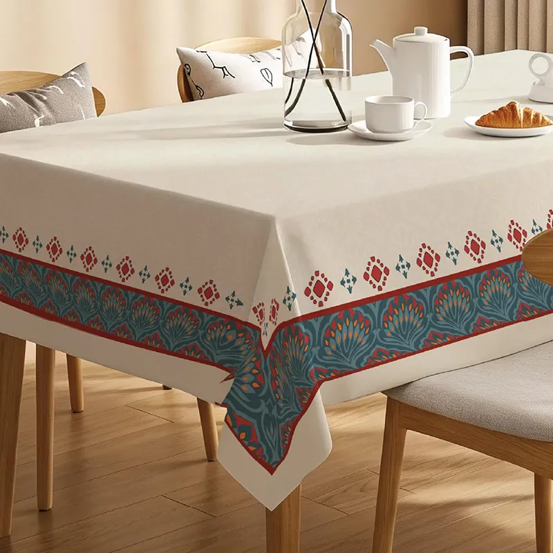 Close view of off-white rectangular table cover with ornate border
