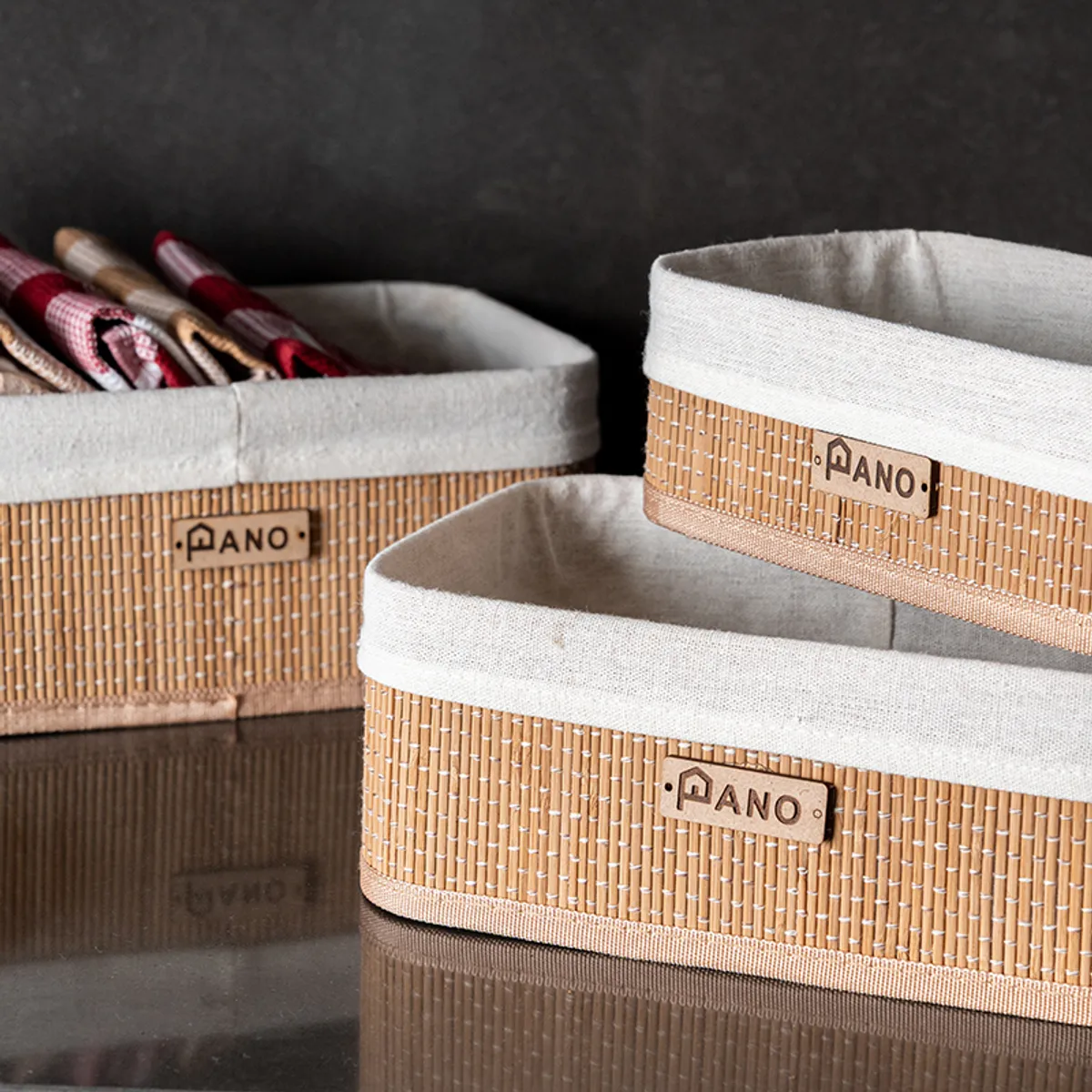 Close-up of three bamboo storage baskets with white fabric lining