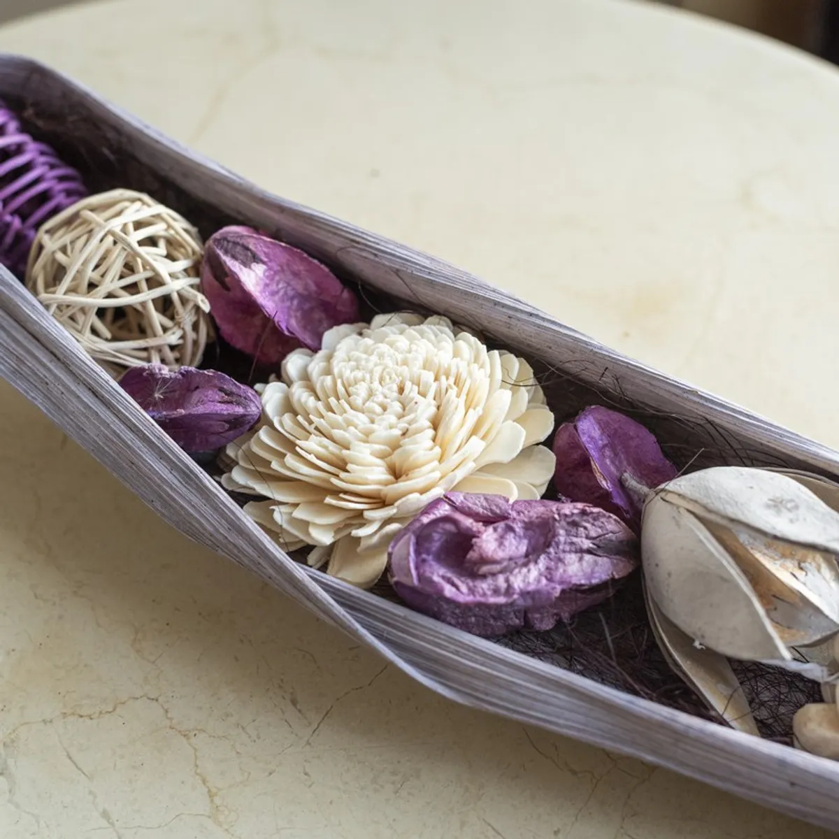 Close-up of purple and off-white artificial flowers with textured botanical details.