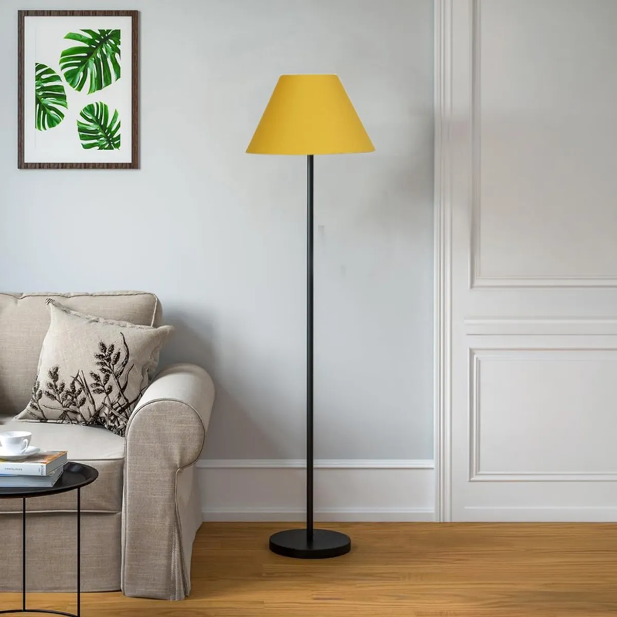 Yellow shade floor lamp next to a beige sofa in a bright living room