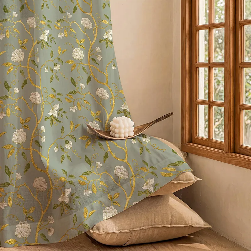 Sage green curtain with gold floral foil print draped beside a wooden window