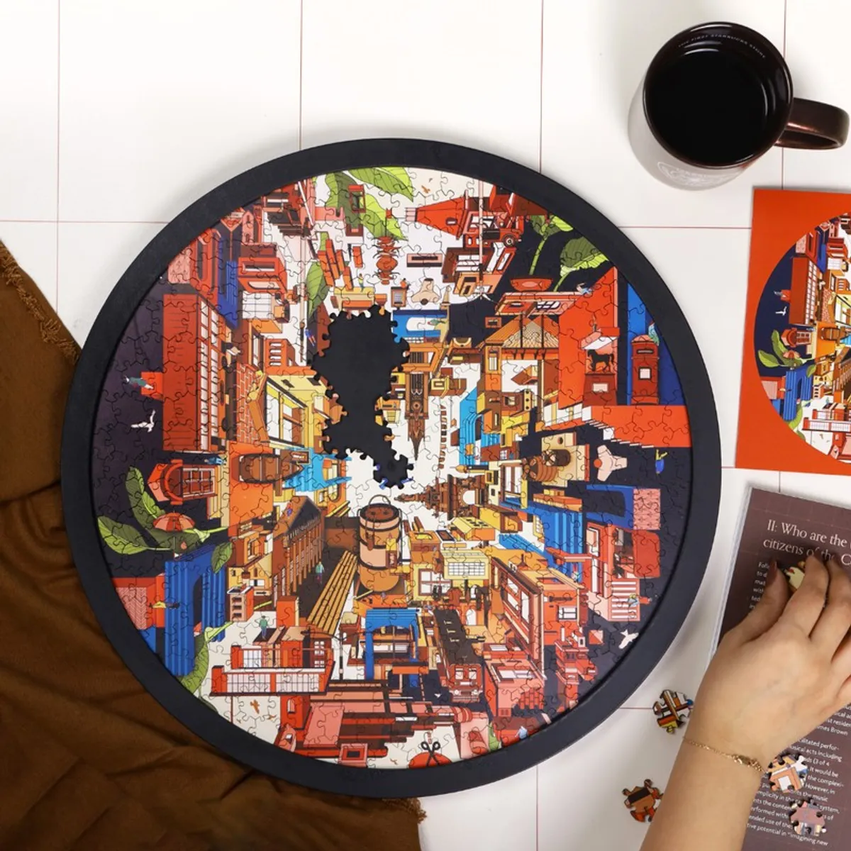 Top view of round cityscape puzzle wall art with a few missing pieces