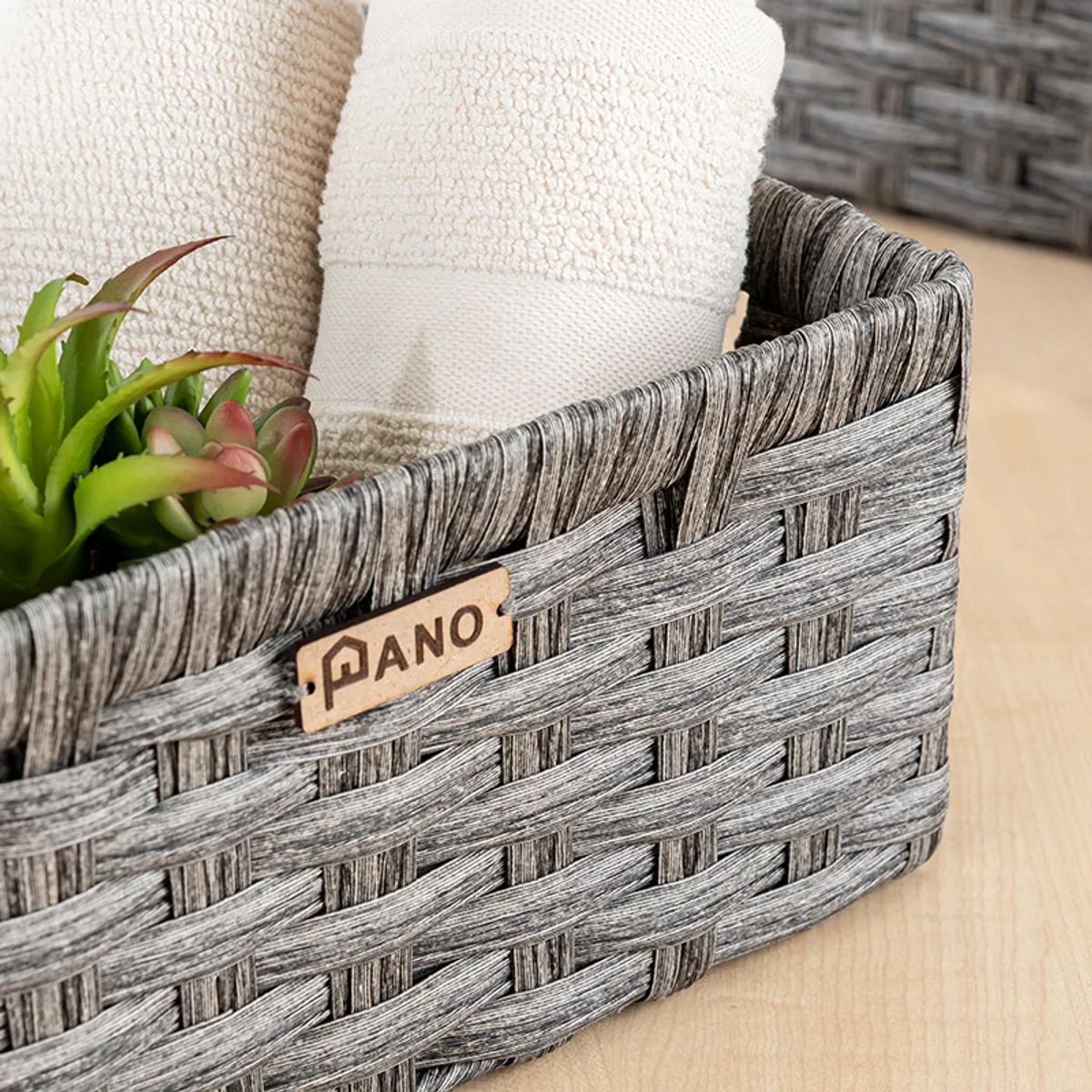 Close-up of a grey rectangular storage basket with toiletries