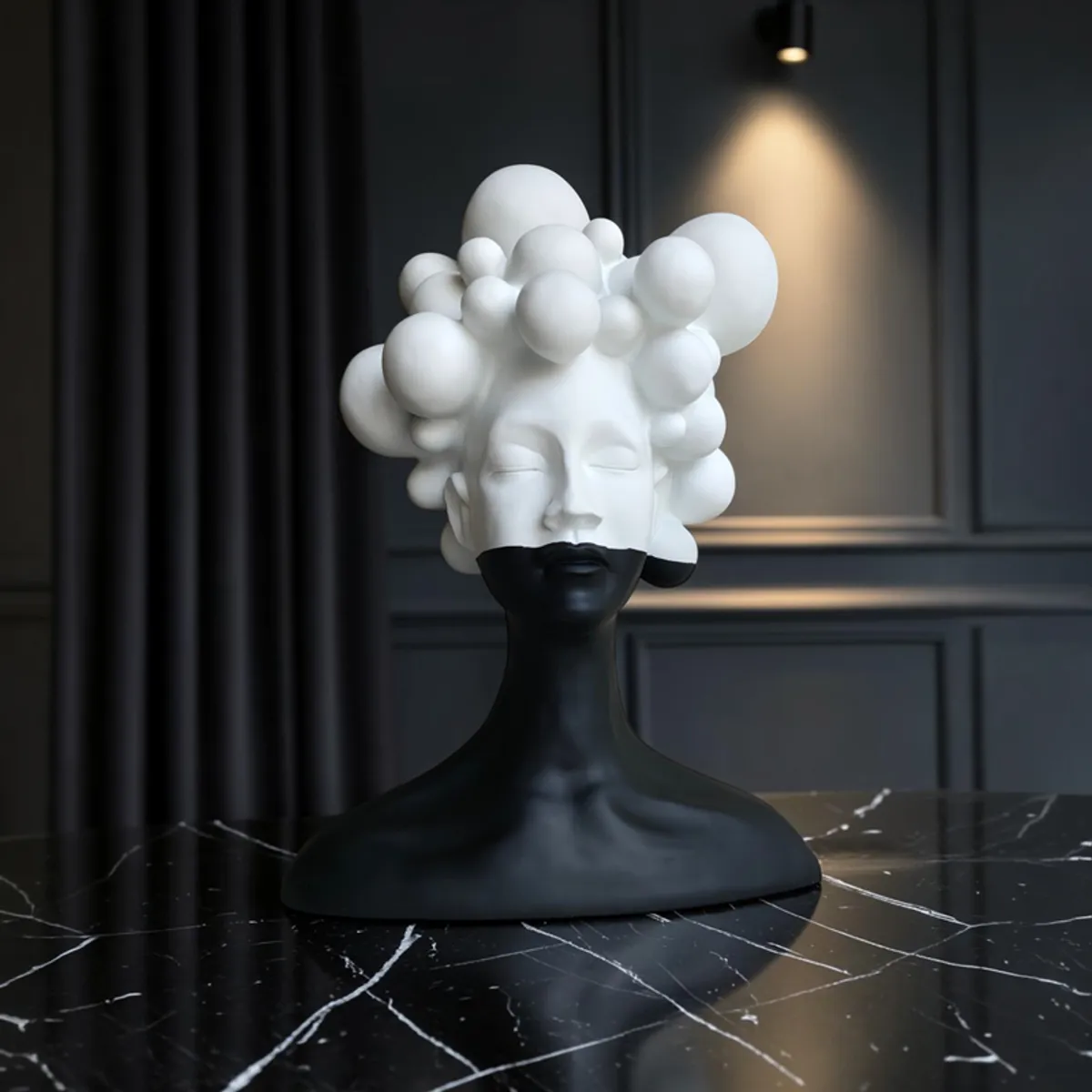 Monochrome bubble bust showpiece displayed on a dark marble surface