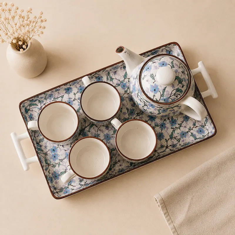 Top view of blue floral ceramic tea set arranged on a tray
