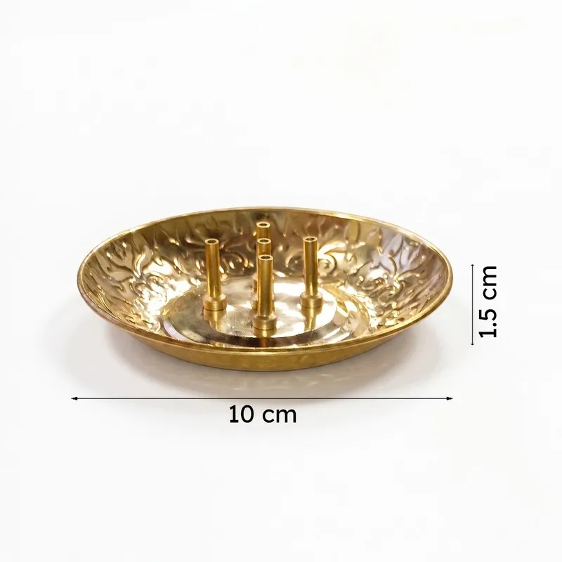 Side view of a round brass incense holder with decorative rim on a white background