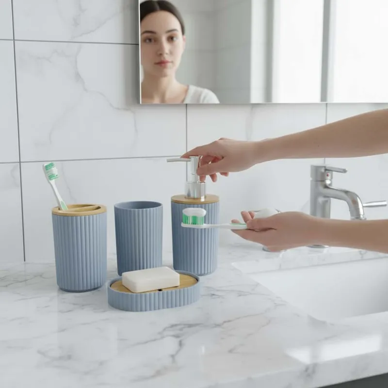 Grey bathroom set shown beside a sink with a dispenser, tumbler, holder and soap dish