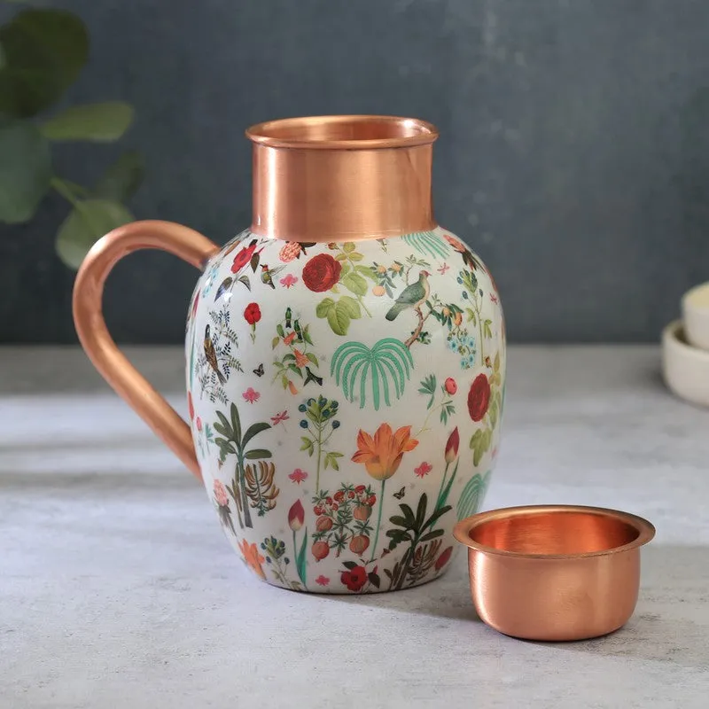Close view of a floral copper jug and matching tumbler on a tabletop