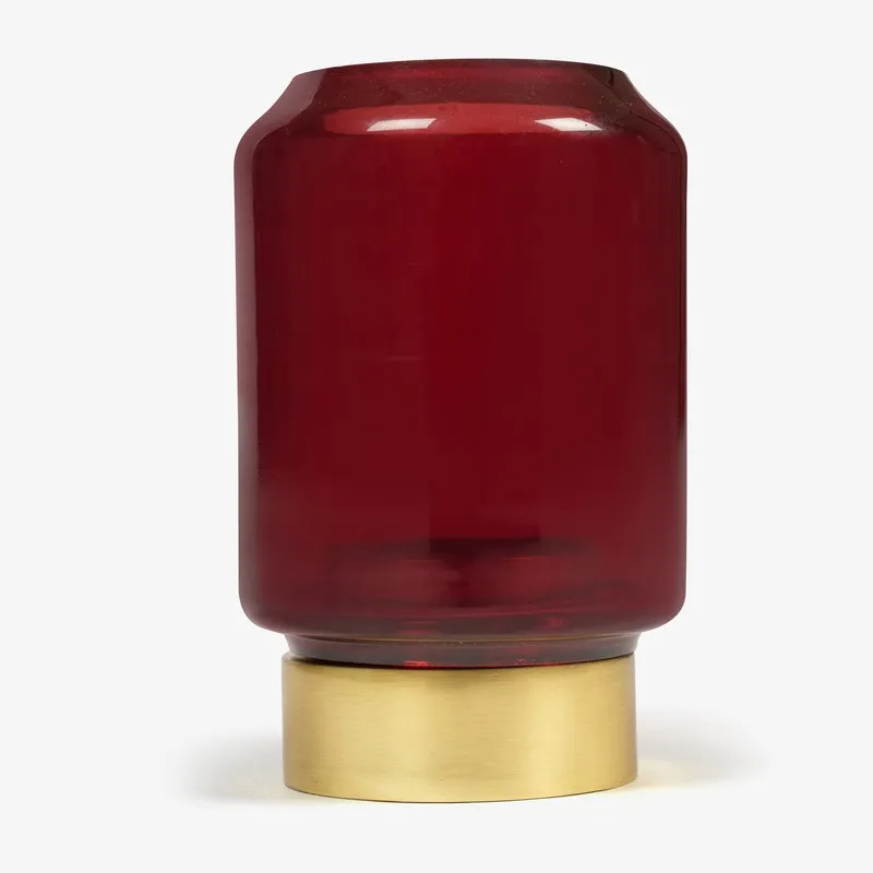 Front view of ruby red glass candle holder with gold base