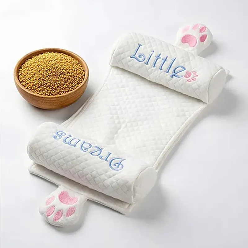 White quilted baby neck pillow with blue embroidery and pink paw details