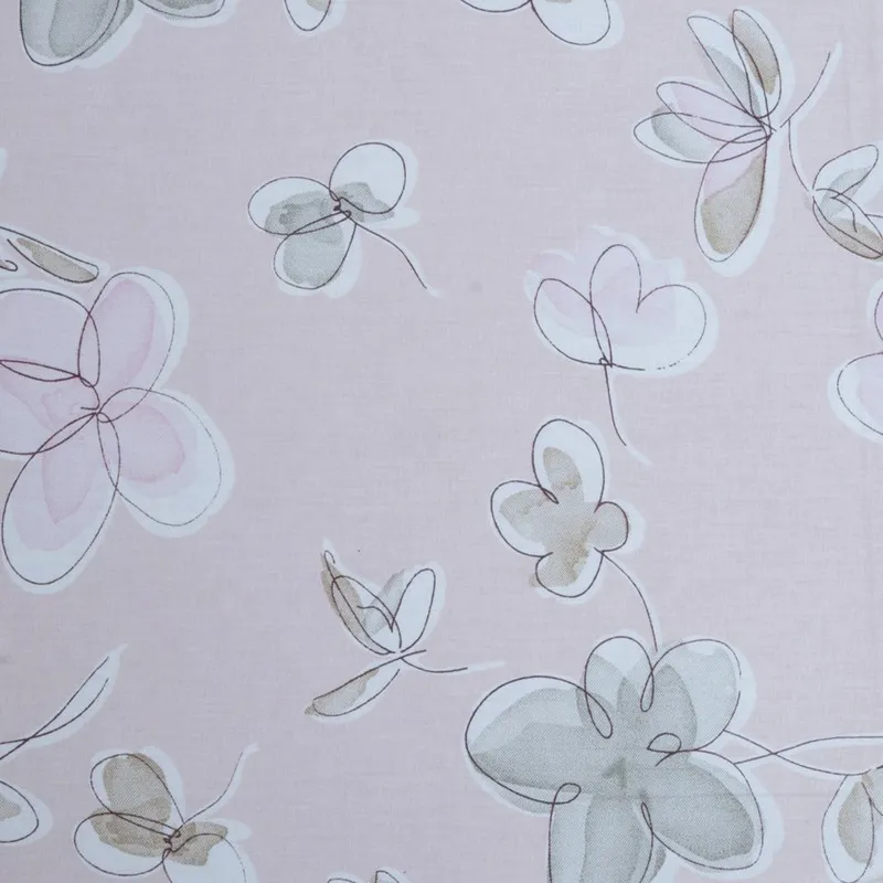 Detailed view of floral and botanical sketch print on pink fabric