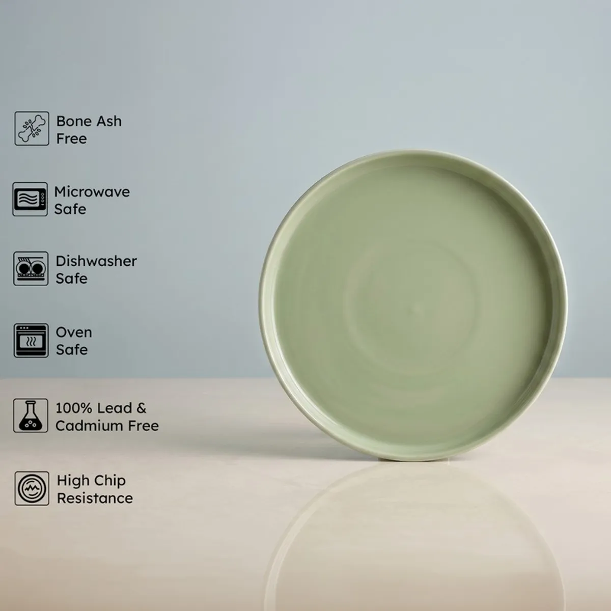Single sage green round dinner plate displayed against a light background