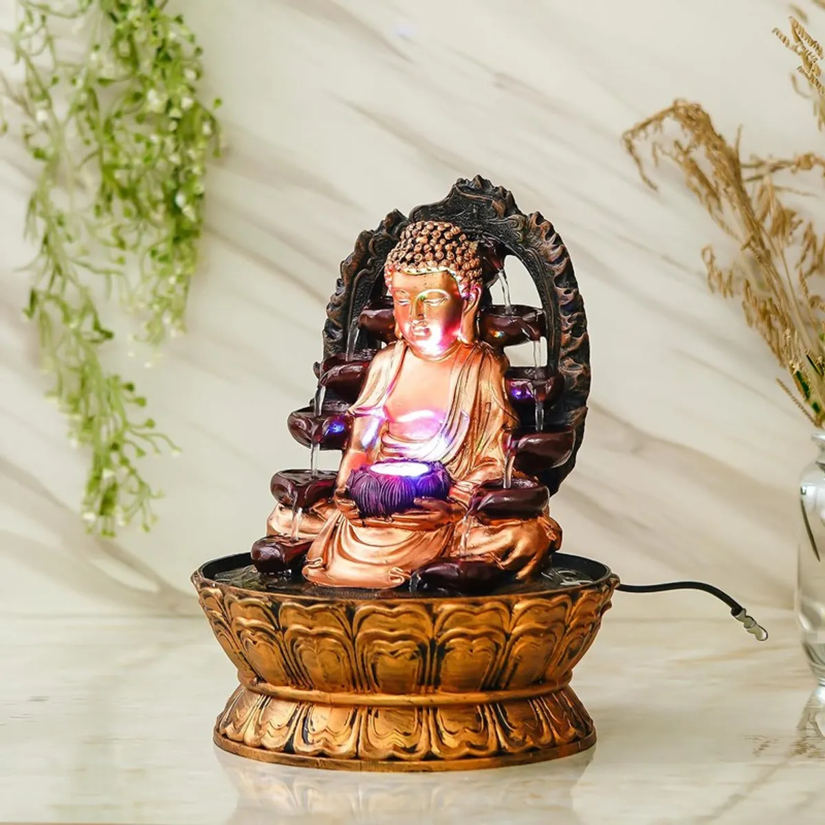 Angled front view of the Buddha LED fountain with flowing water and lotus-style base