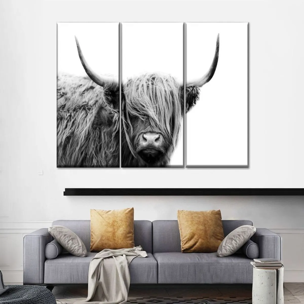 Large three-panel Highland bull canvas art displayed above a sofa