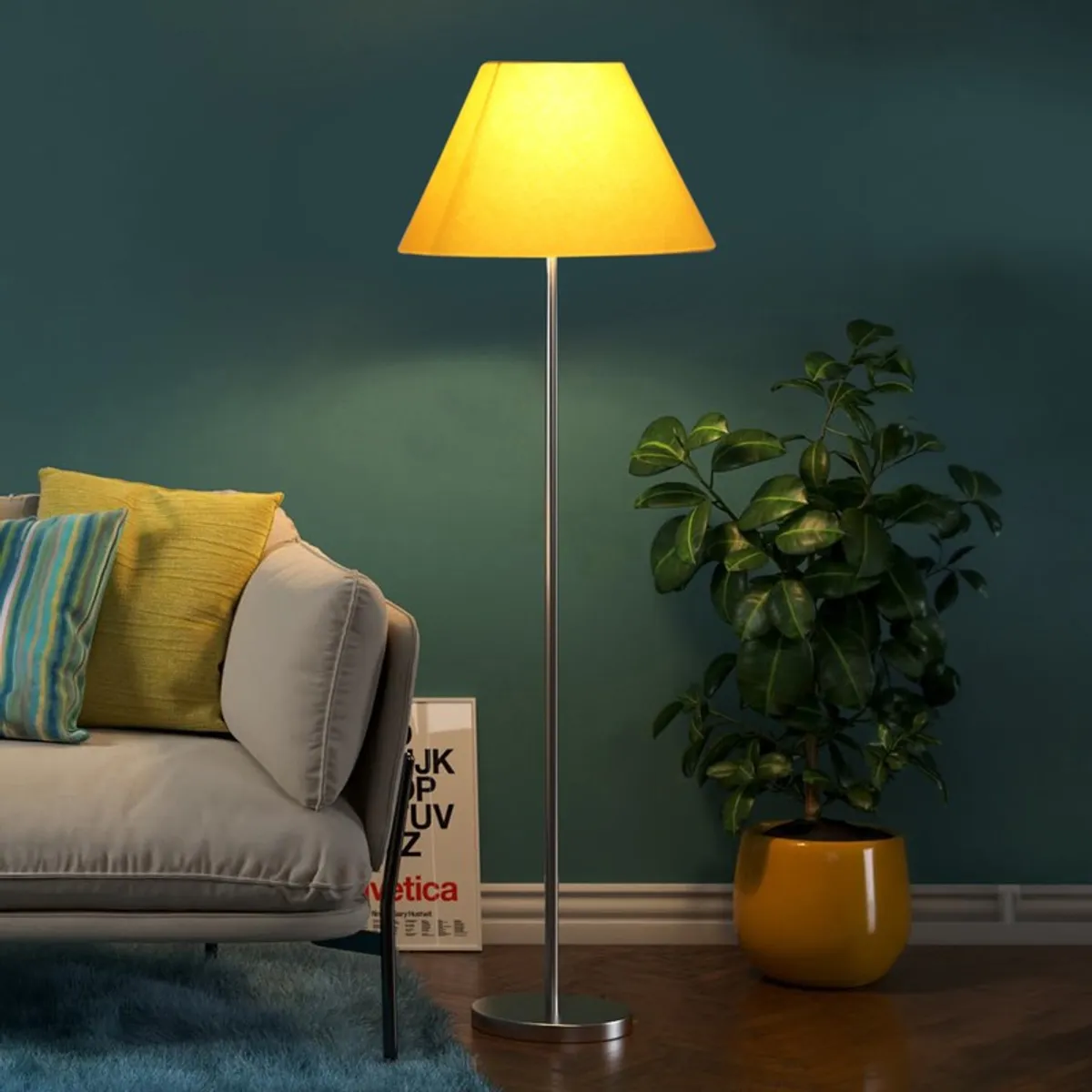 Yellow floor lamp switched on beside a sofa and plant against a teal wall