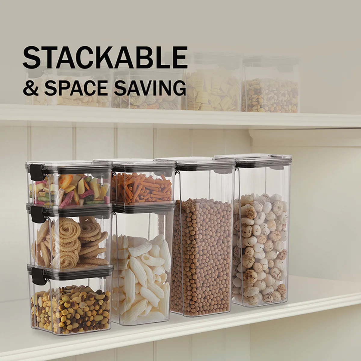 Clear stackable pantry containers with black lids arranged on a shelf