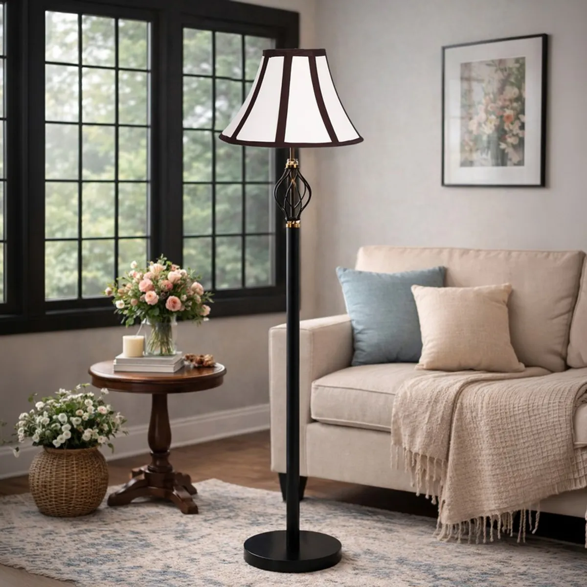Tall black floor lamp with white paneled shade styled near a sofa and round side table