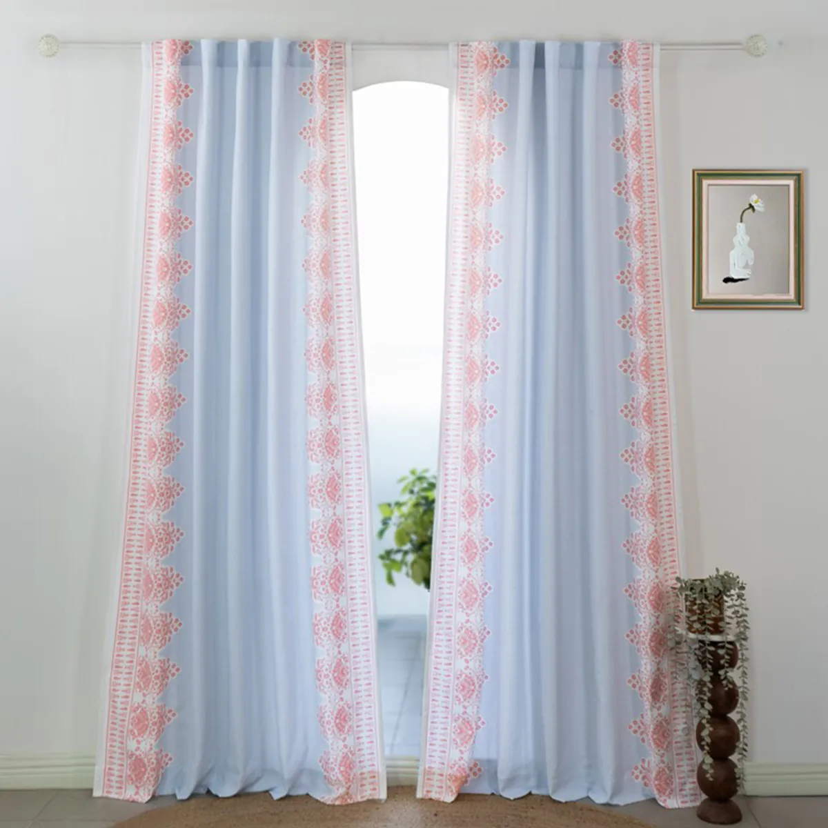 Pair of blue and pink floral curtains hanging across a window