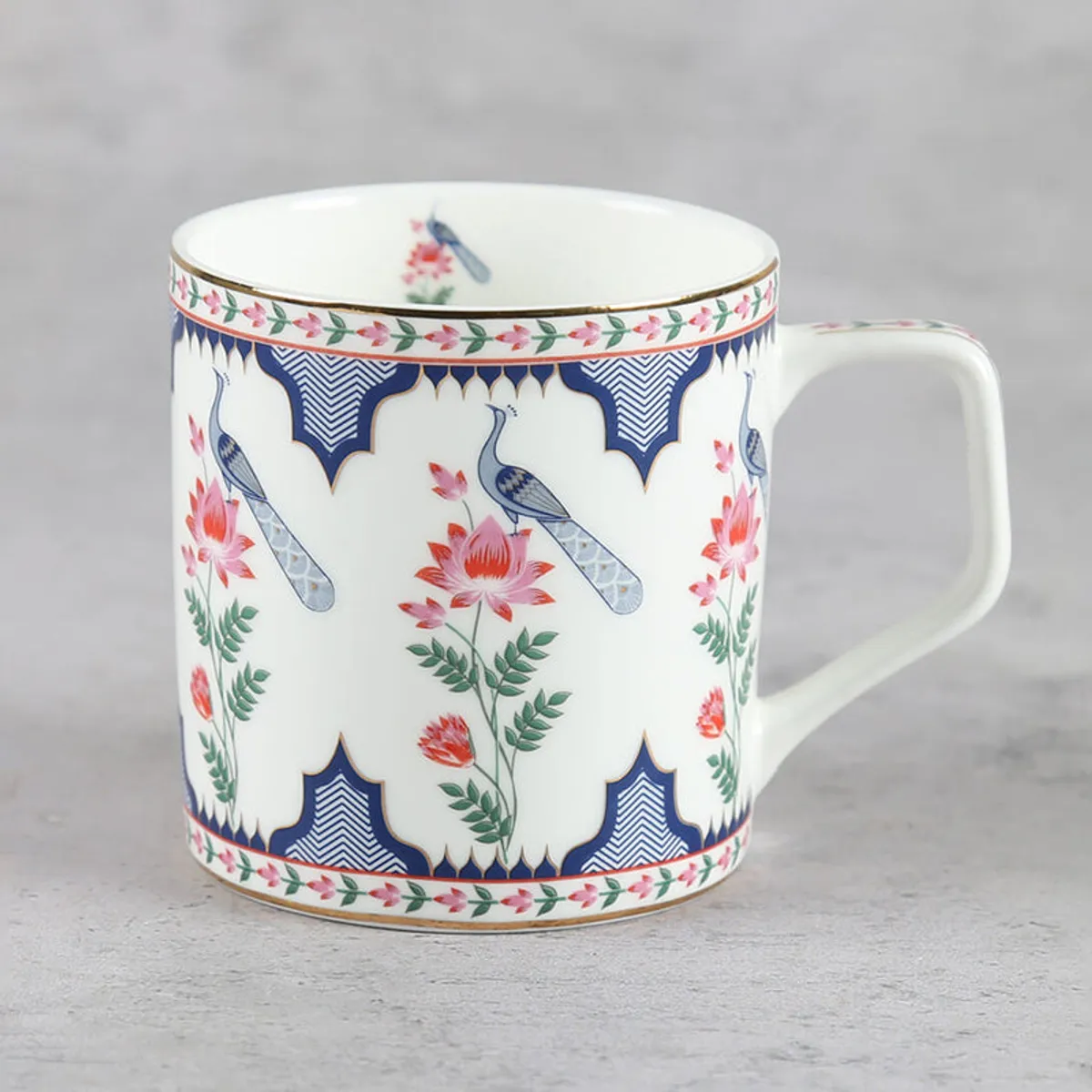 Single ivory tea cup with peacock, floral motif and gold rim