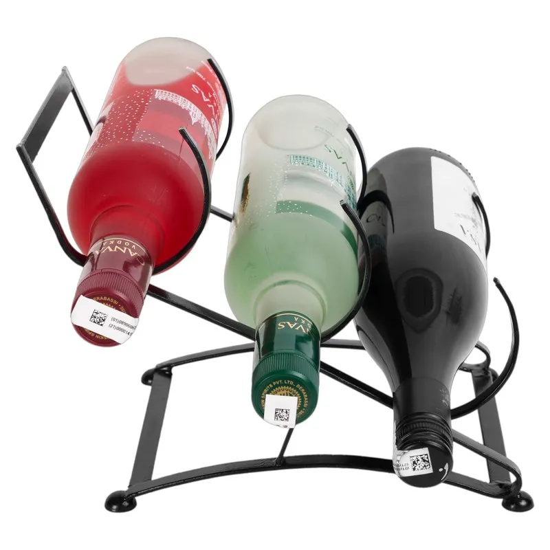 Close view of three wine bottles resting in the black iron holder.