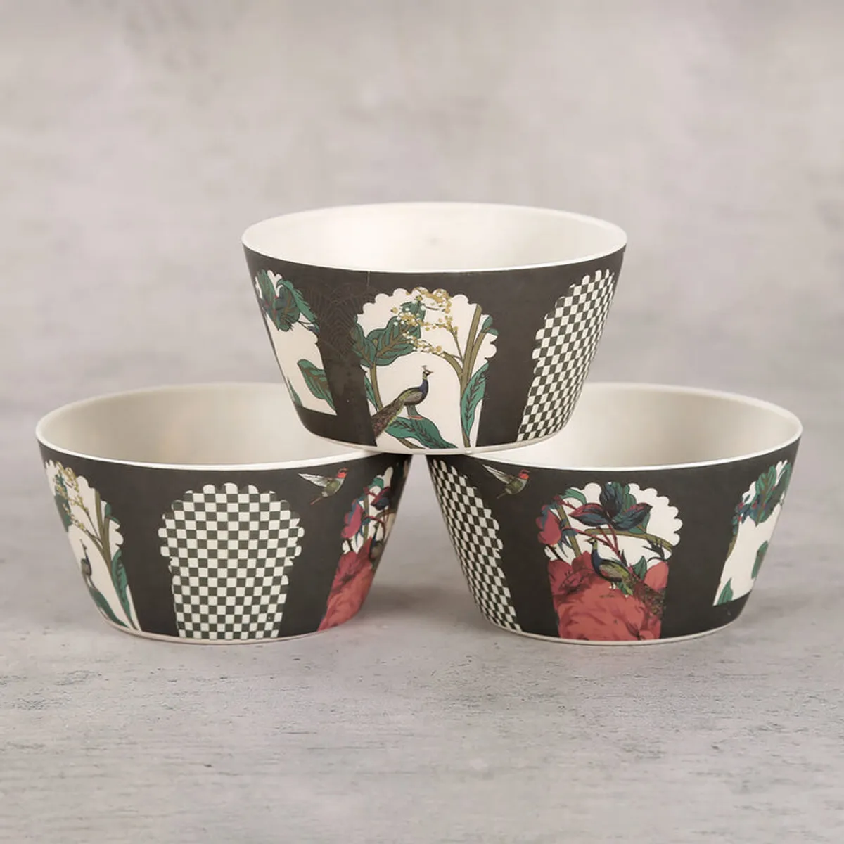Three dark snack bowls showing floral, peacock and checked designs