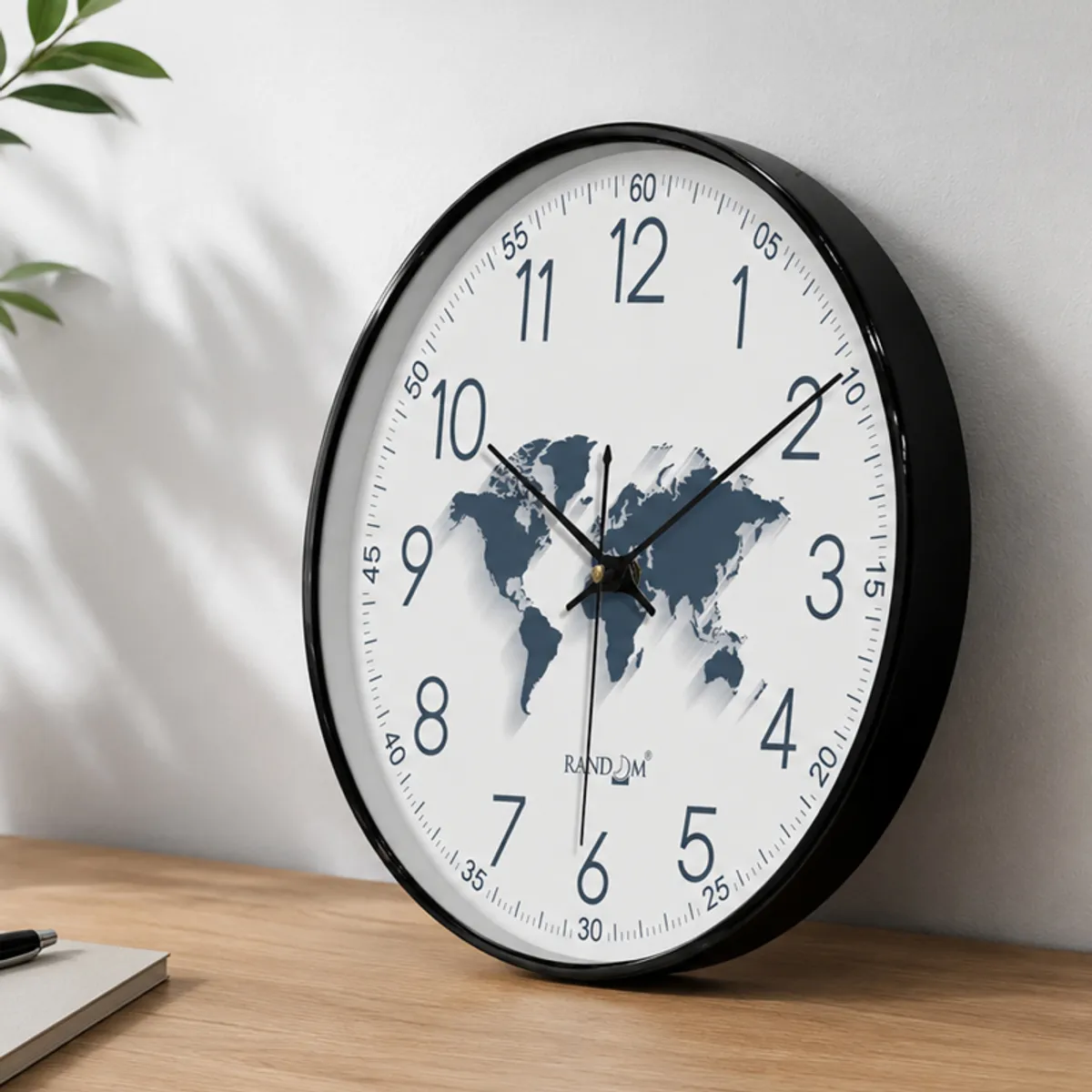 Side view of the round wall clock showing its black rim and white world-map dial.