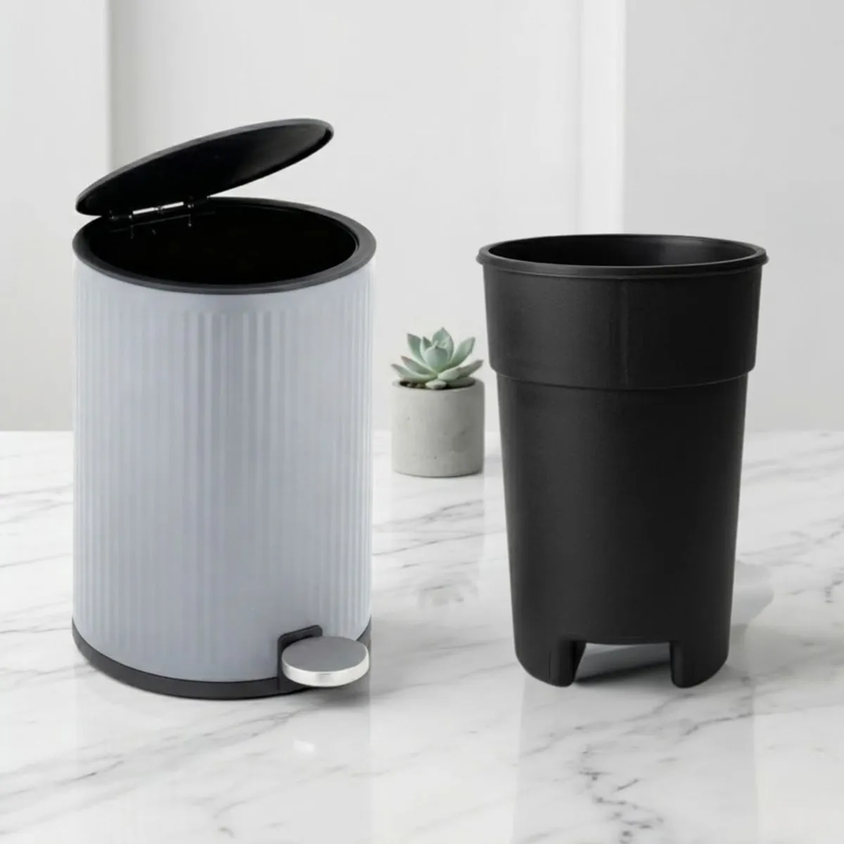 Grey metal dustbin with removable black inner bucket beside it