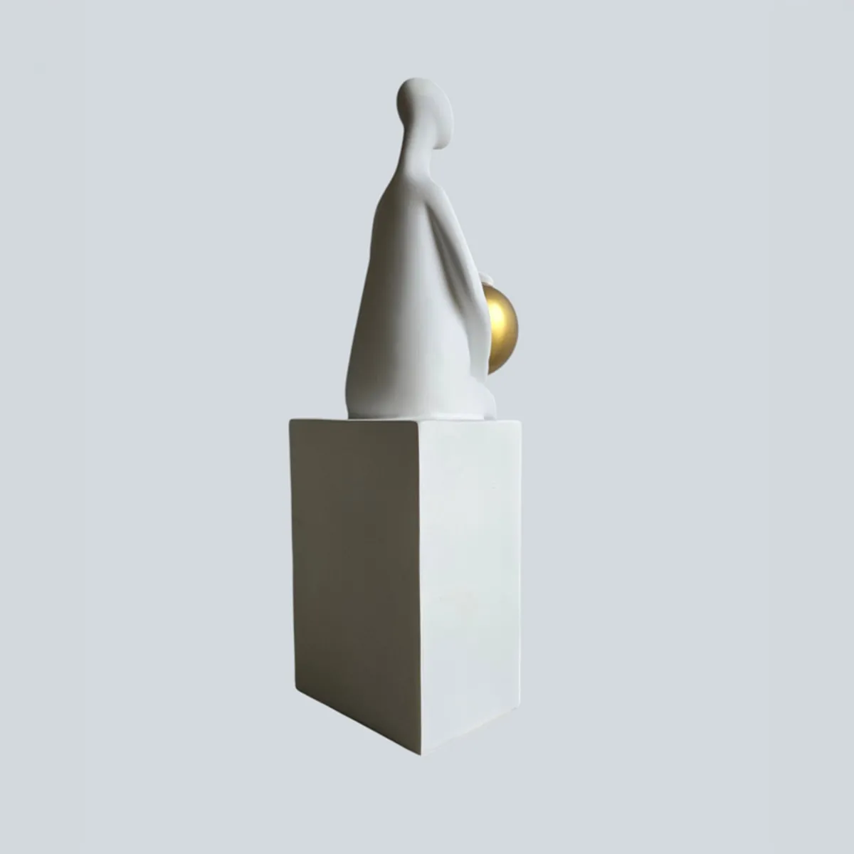 Rear three-quarter view of the white figurine on a rectangular base