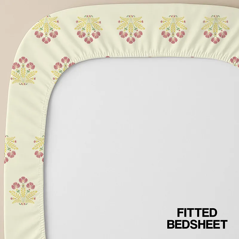 Off-white fitted bedsheet corner with floral print and elasticated edge