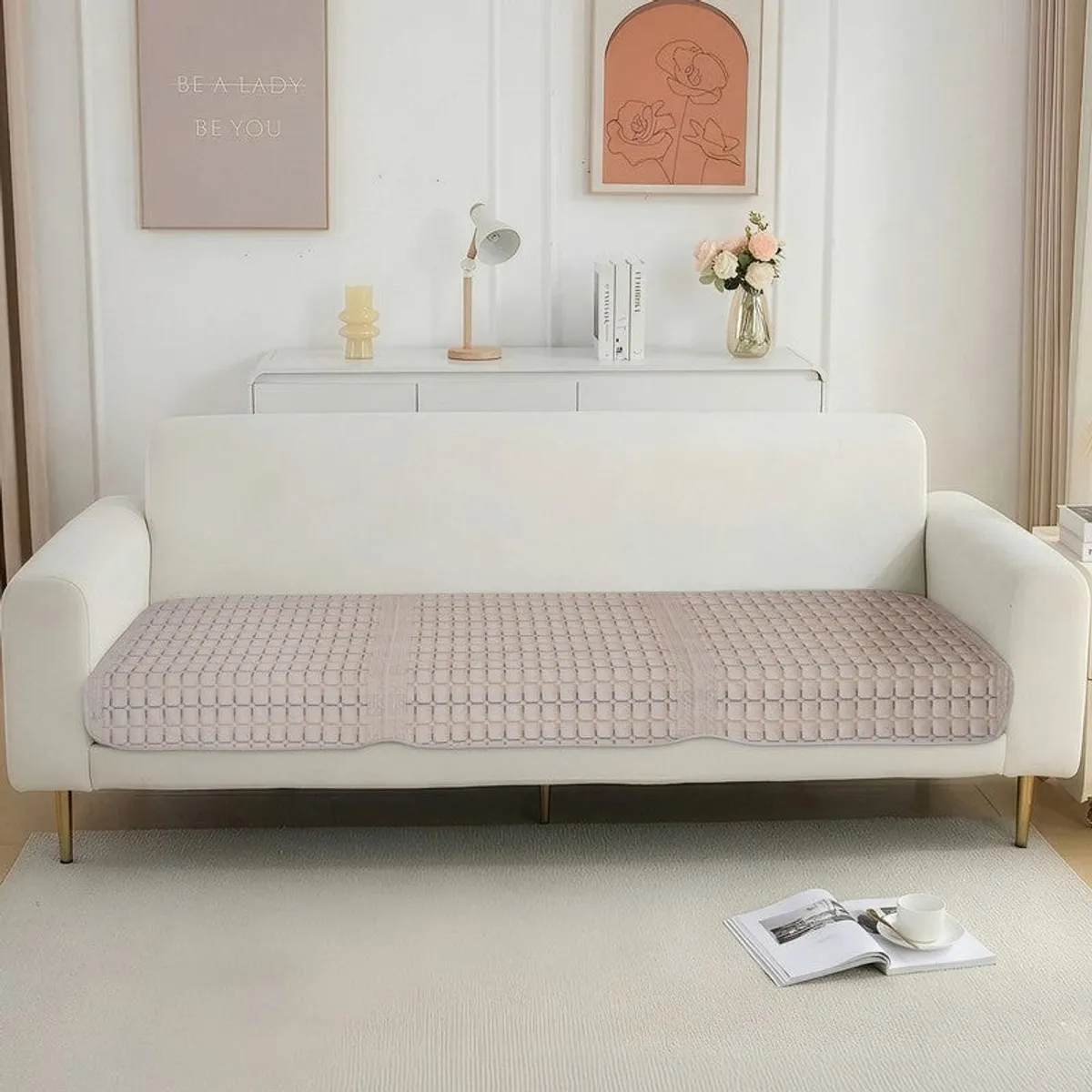 Beige geometric velvet cover arranged across a three-seater sofa