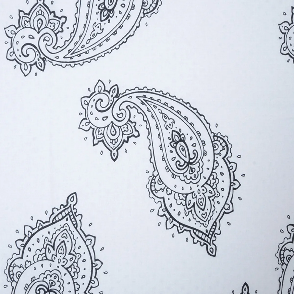 Detailed view of large black paisley motifs on white bedding