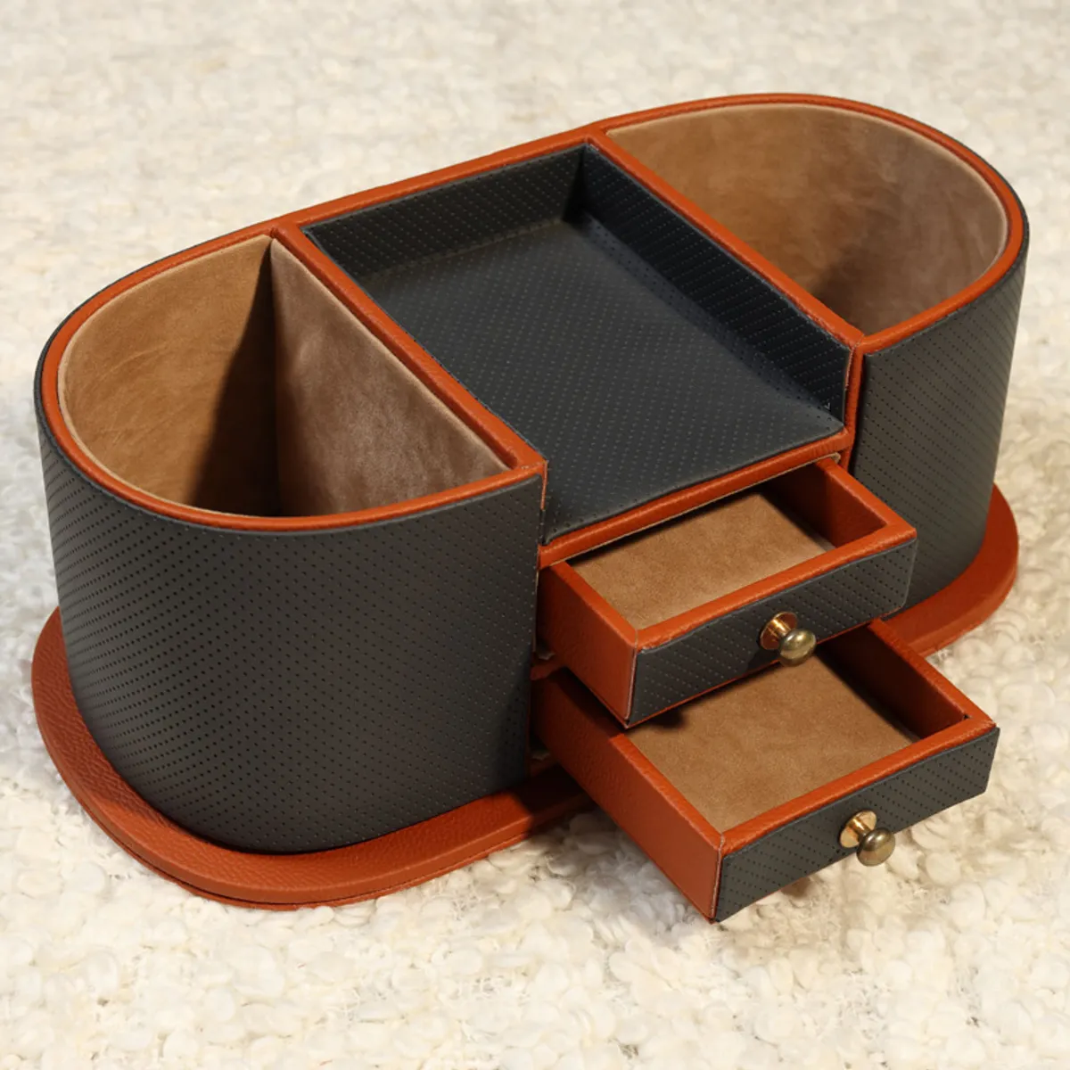 Grey and brown organiser with open drawers photographed on a light textured surface